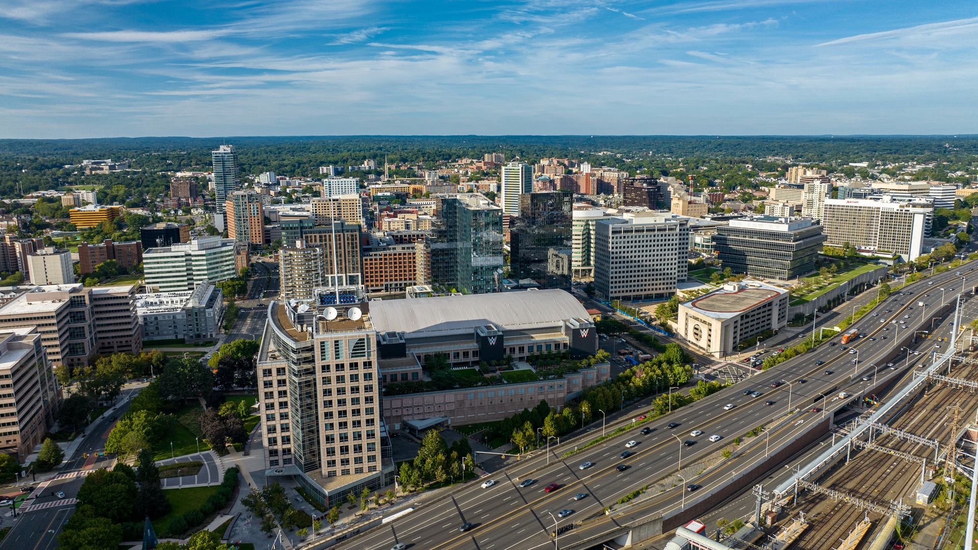 An aerial view of a city with a highway and lots of buildings. An aerial view of a city with a highway and lots of buildings.