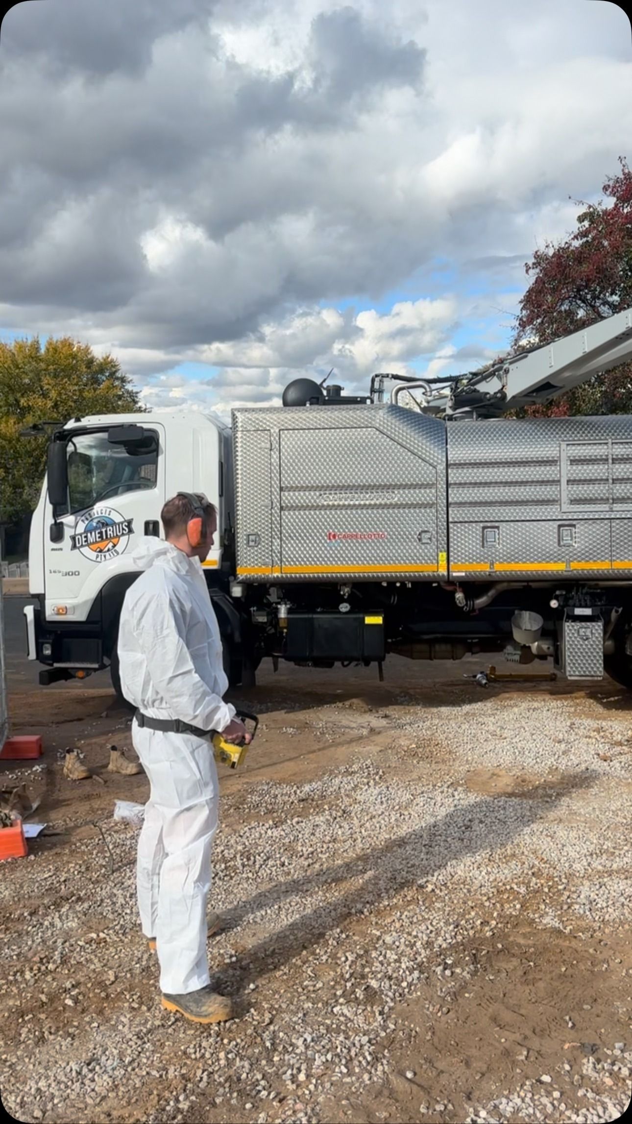 Man in White Suit Stands Near a White Truck — Demetrius Projects in Queanbeyan East, NSW