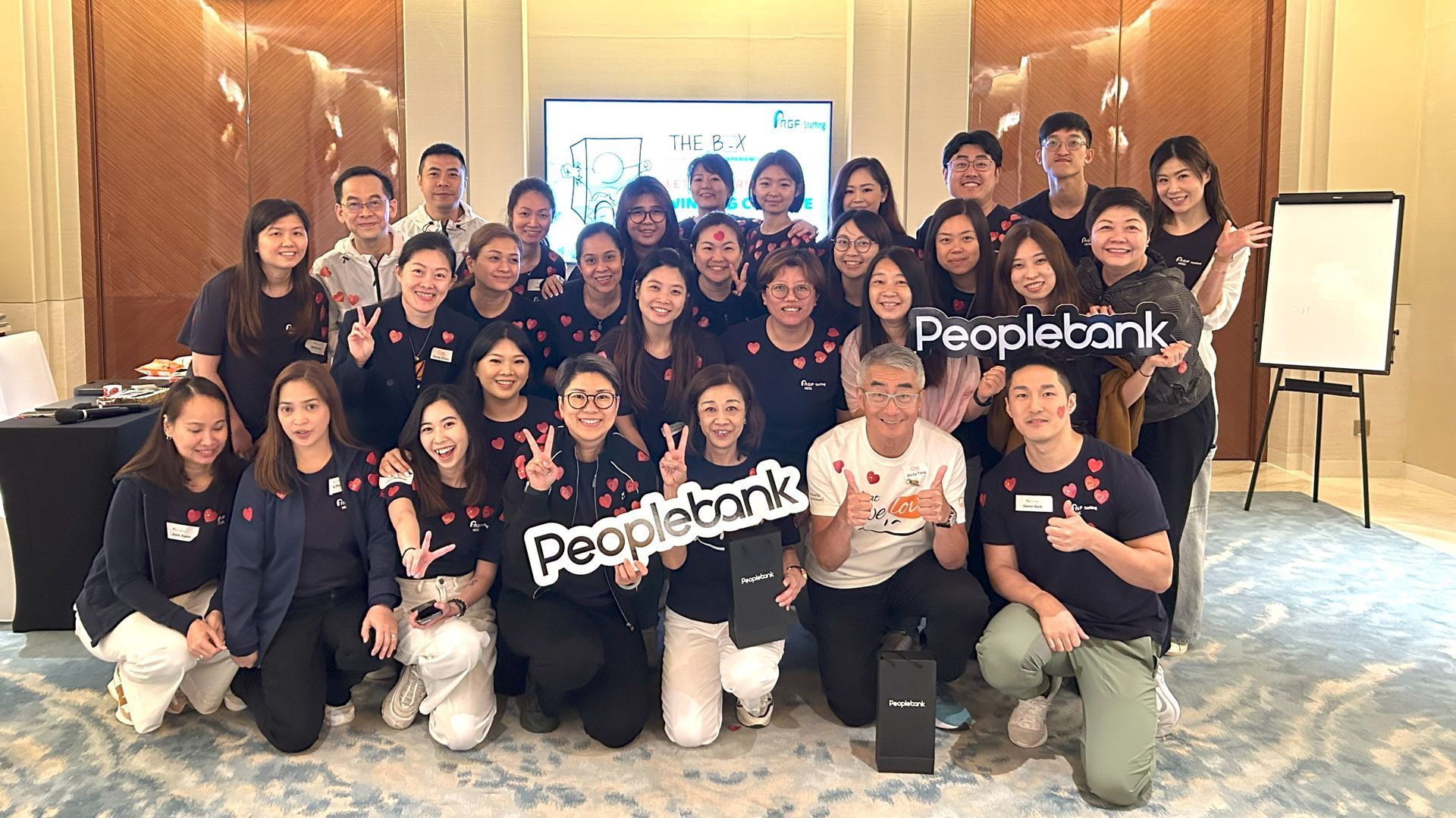 A group of people are posing for a picture in a room.