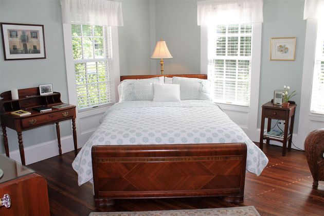 A bedroom with a king size bed and a desk