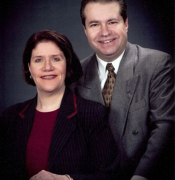 A man and a woman are posing for a picture