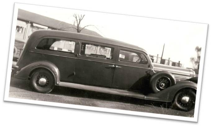 A black and white photo of an old ambulance