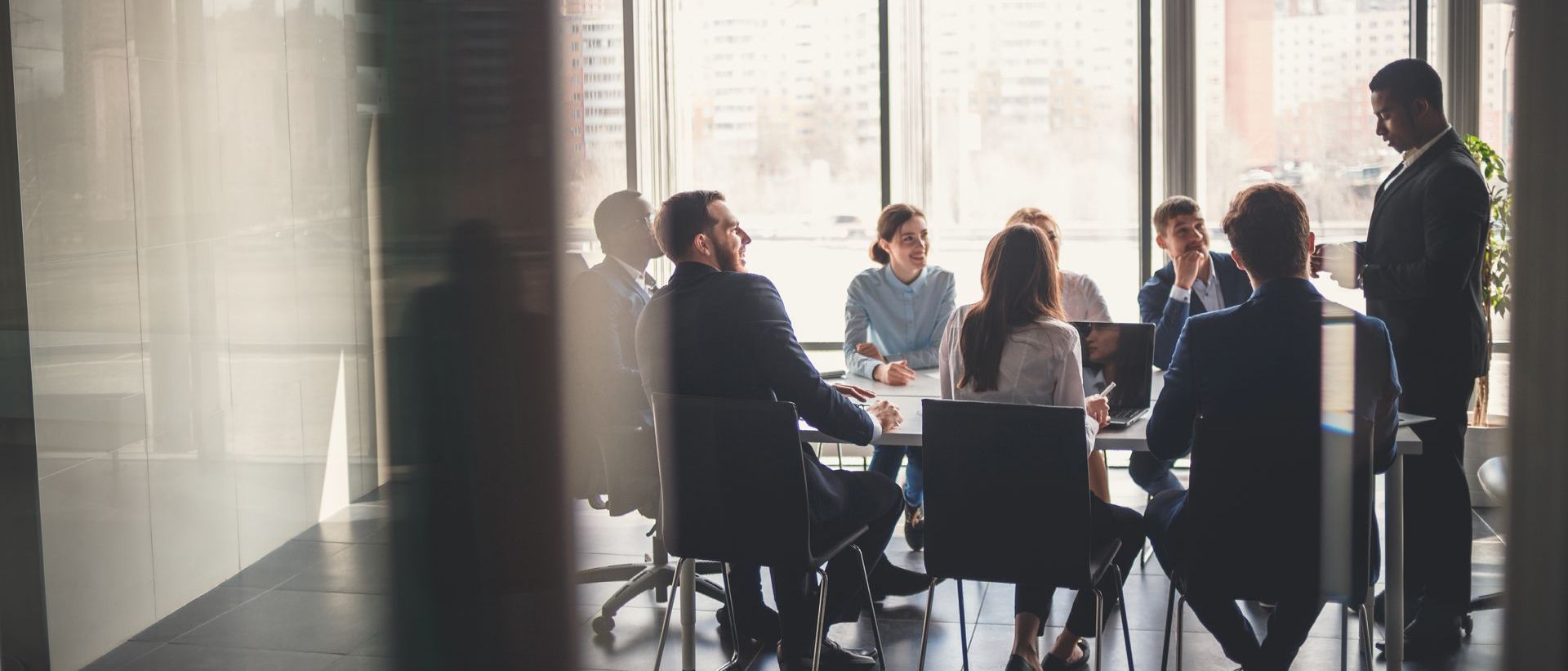 a group of business people are having a meeting in a conference room .
