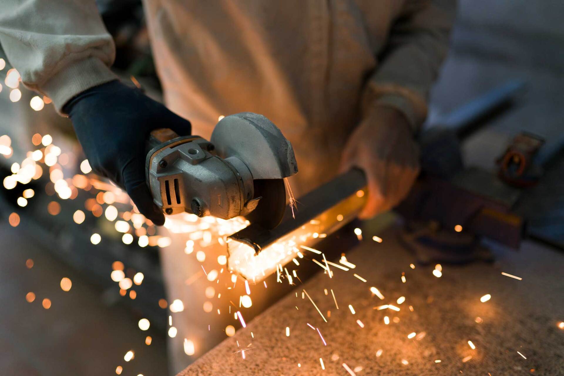 Man Cutting an Iron Bar with a Cutter — Los Angeles, CA — LW Designs