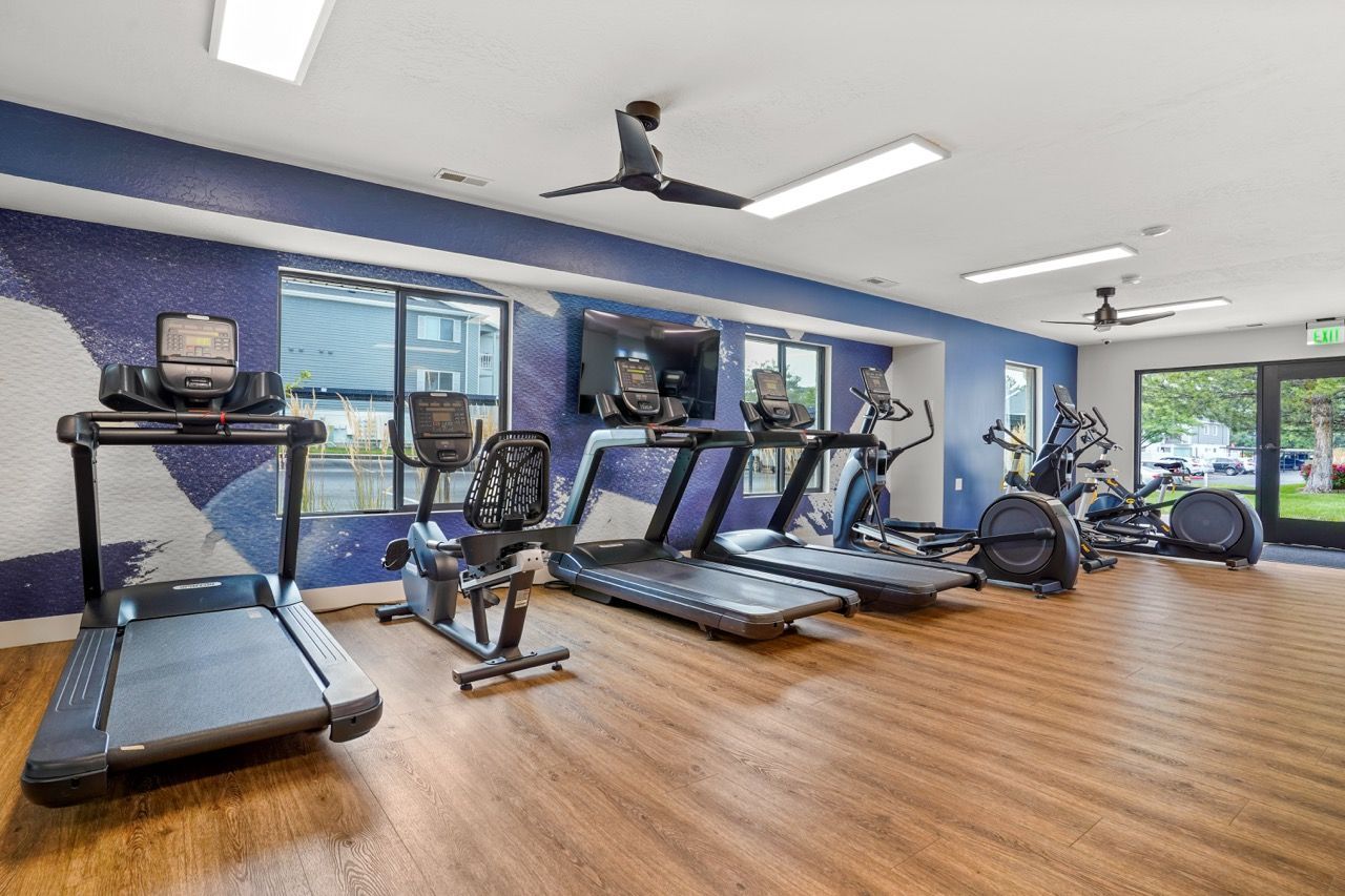 Gym interior with treadmills, ellipticals, and bikes in a modern open space. Discover elevated living by touring the luxury apartments in Millcreek, UT, available at Turnberry Apartments.