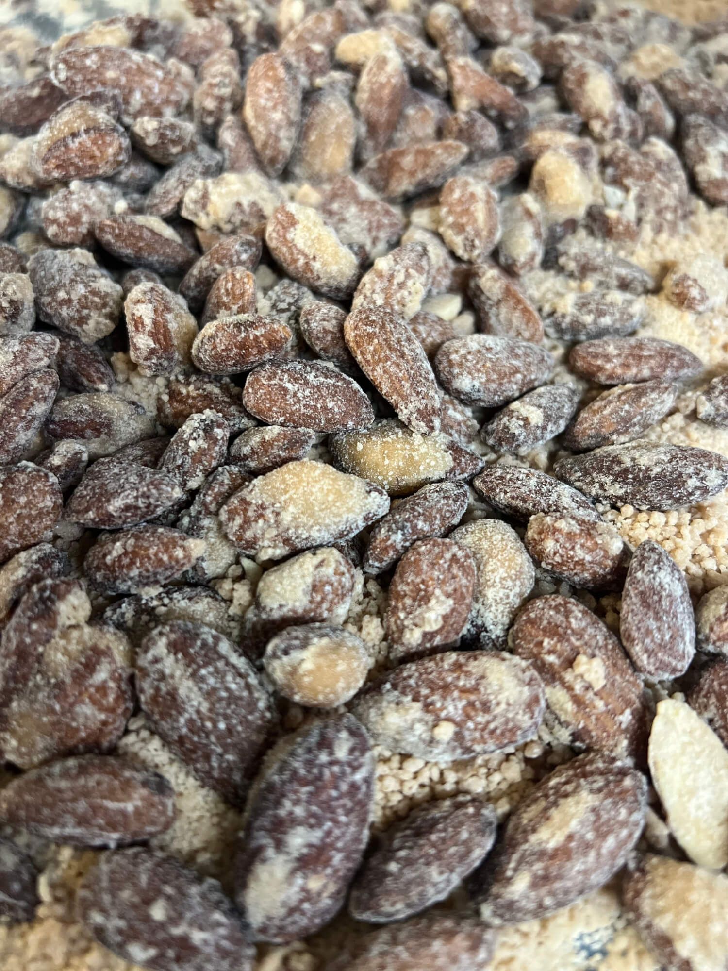 A pile of nuts covered in powdered sugar on a table.