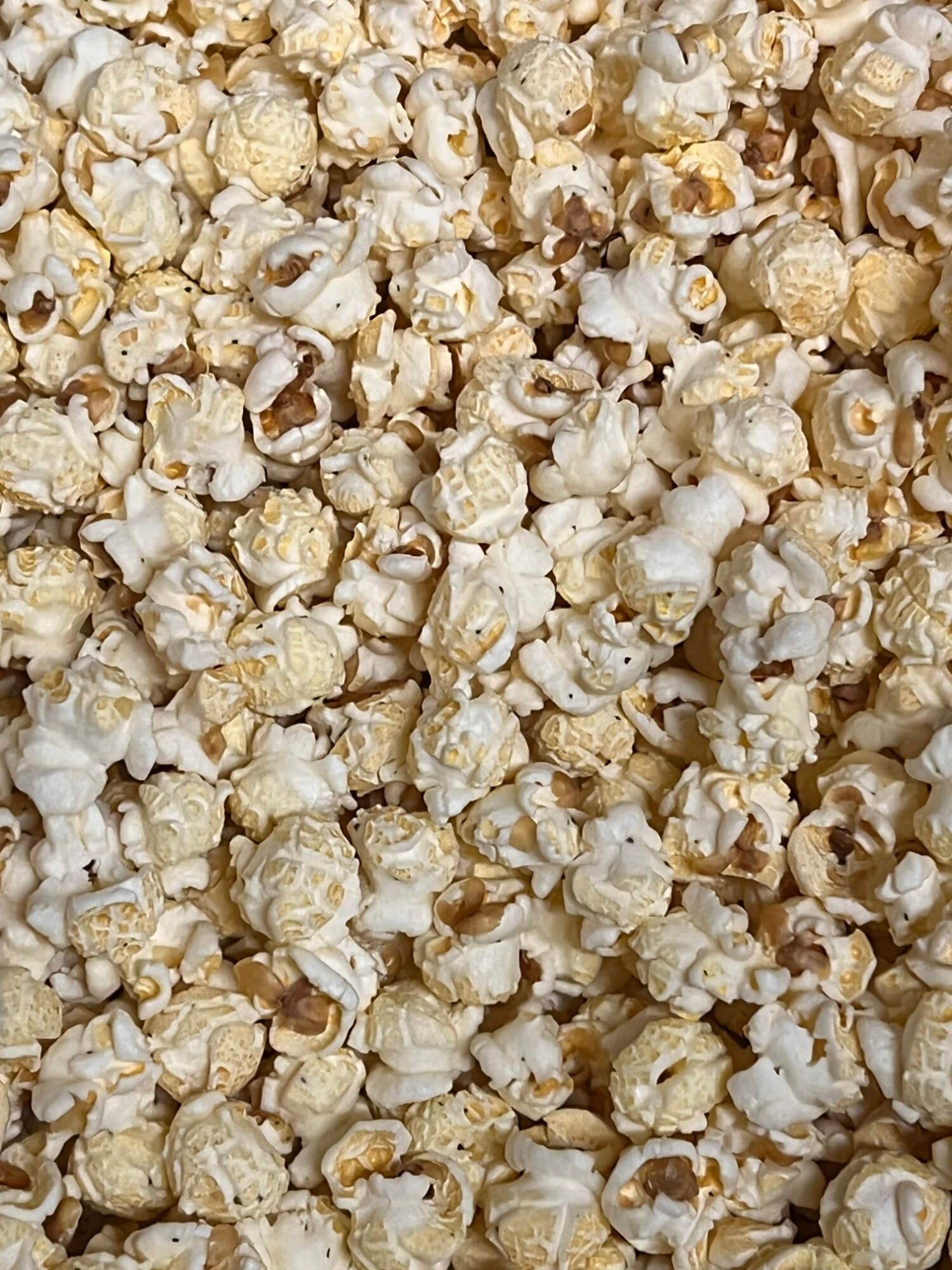 A pile of popcorn is sitting on a table.