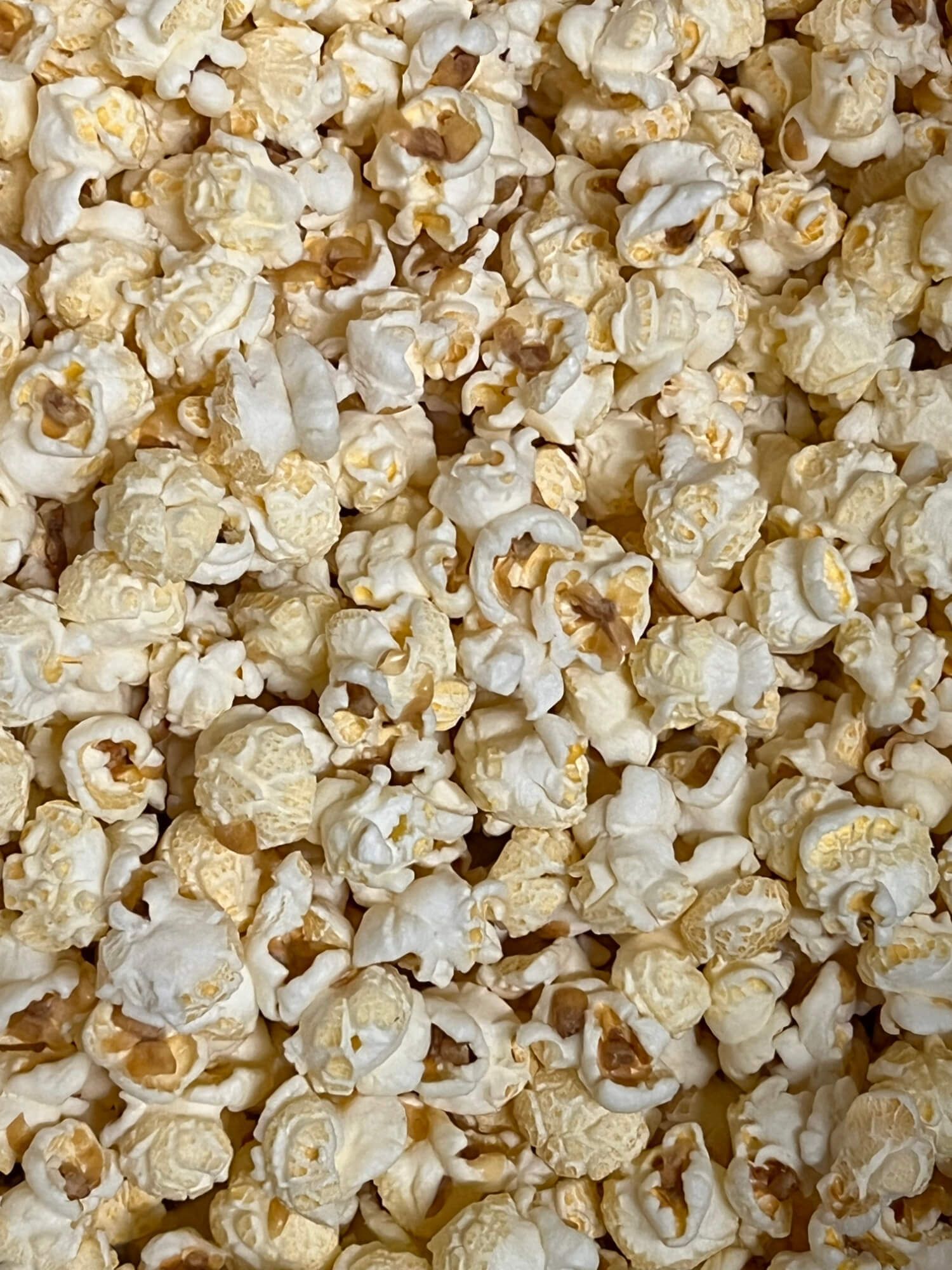 A close up of a pile of popcorn on a table.