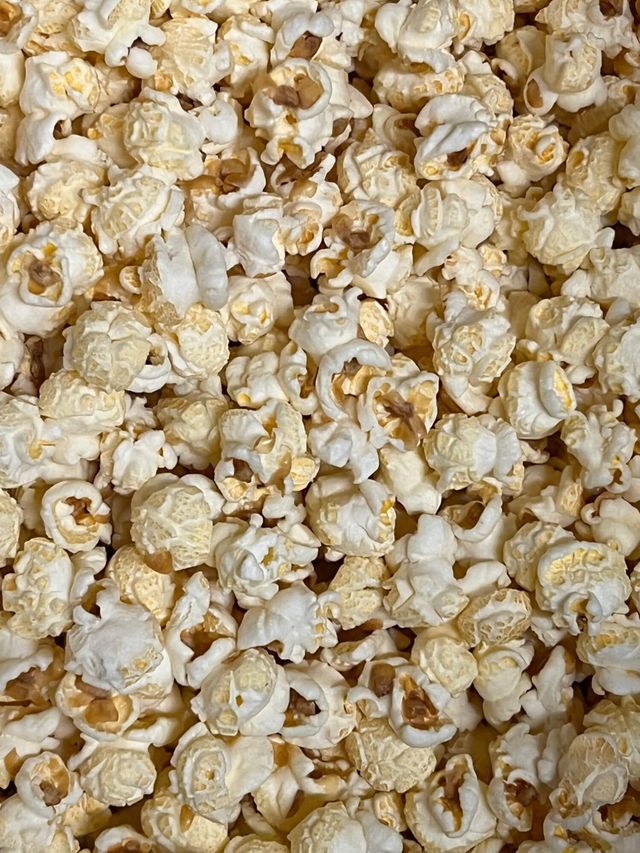 A close up of a pile of popcorn on a table.