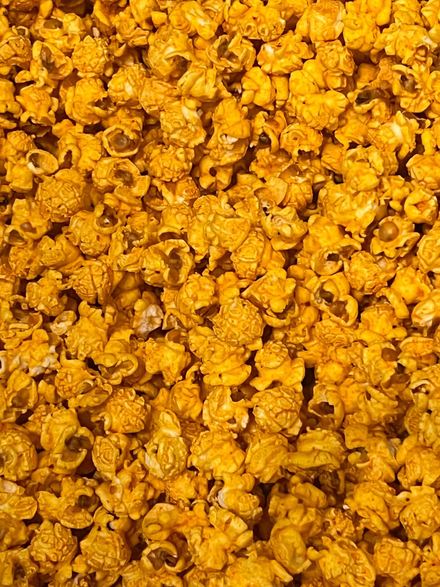 A close up of a pile of caramel popcorn.