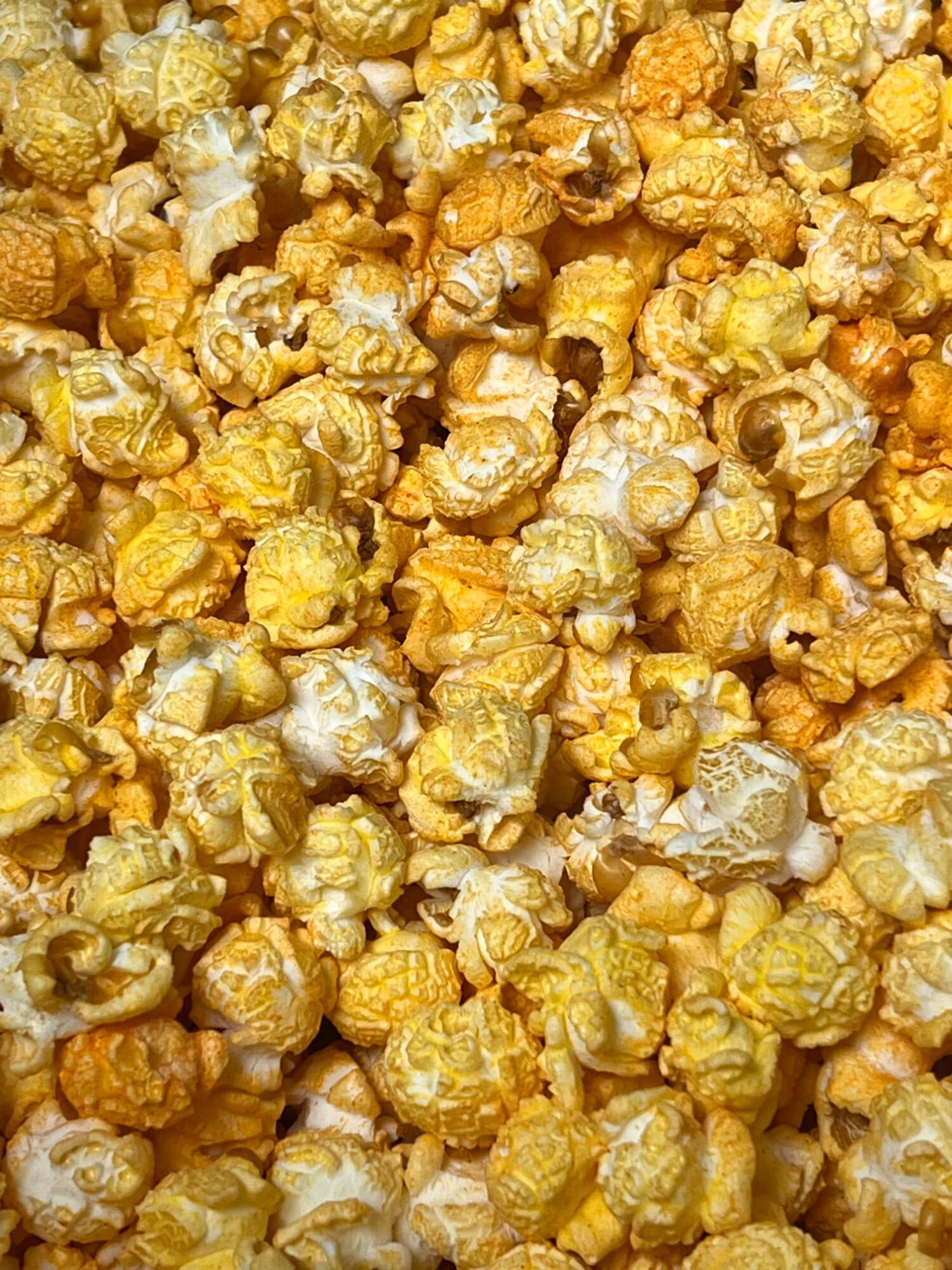 A close up of a pile of caramel popcorn.