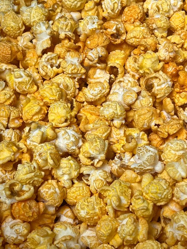 A close up of a pile of caramel popcorn.