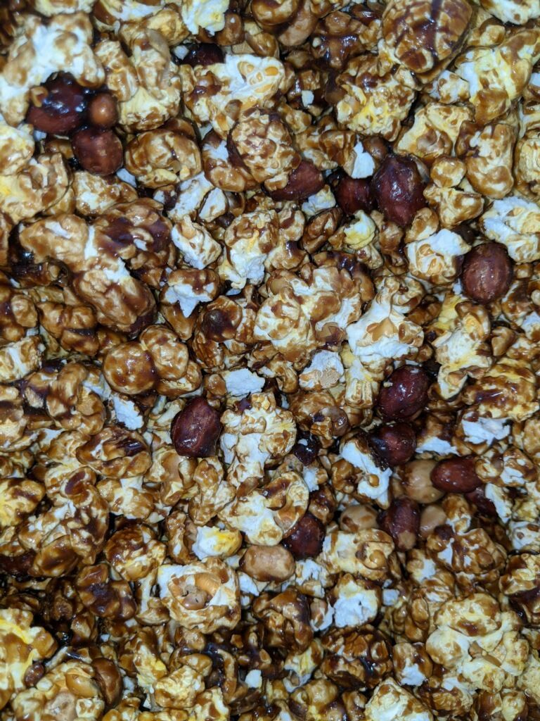 A close up of a pile of popcorn and peanuts.