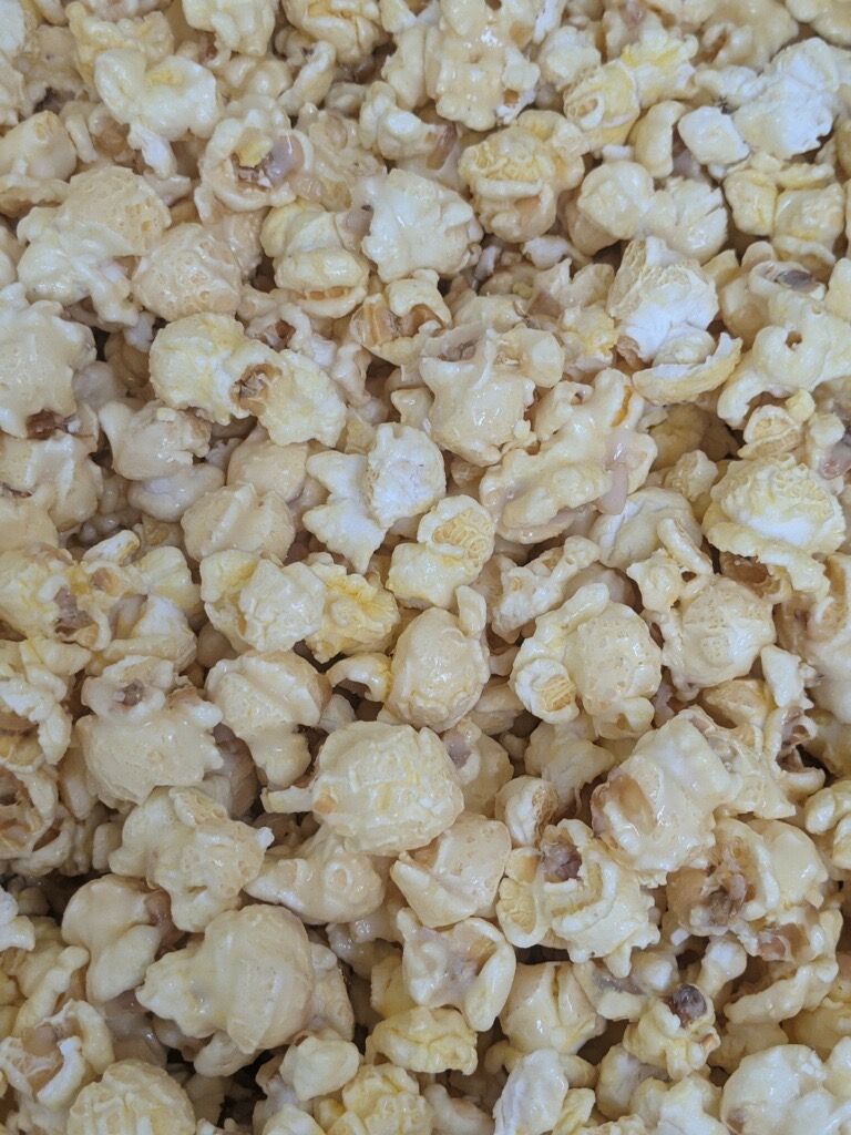 A close up of a pile of popcorn on a table.