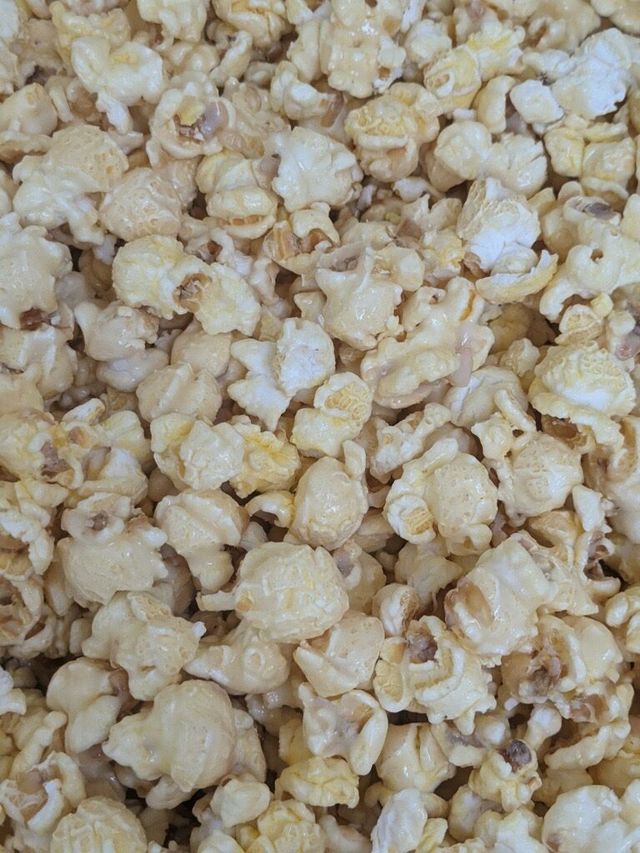 A close up of a pile of popcorn on a table.