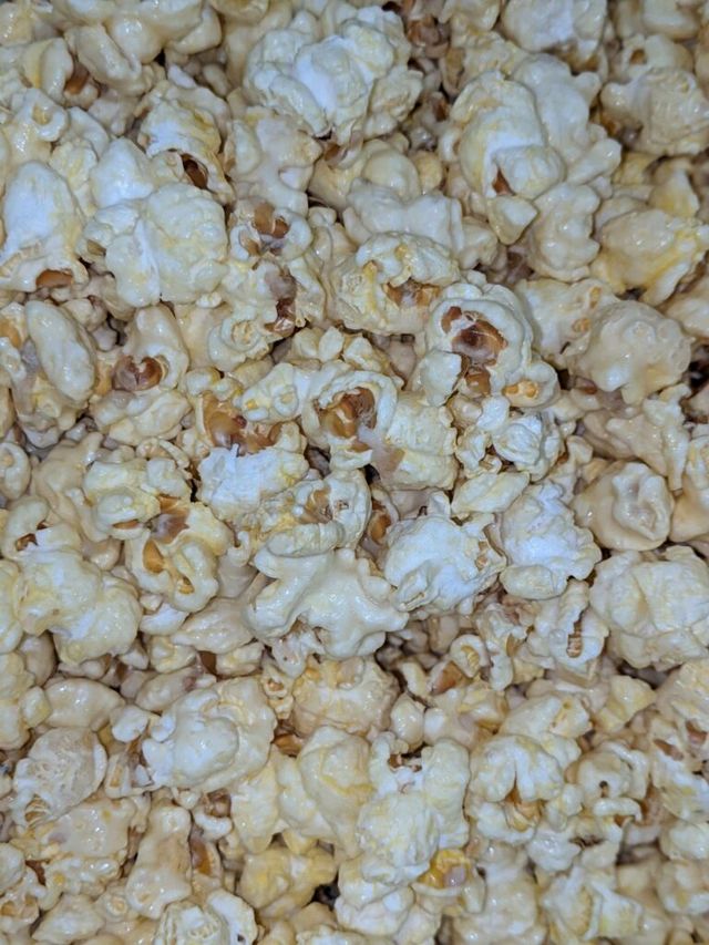 A close up of a pile of popcorn on a table.
