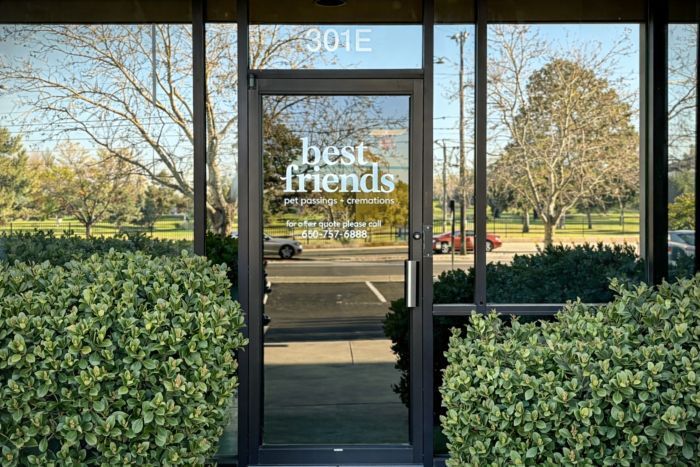 Best Friends entrance for Rio Rancho, NM pet cremation with glass door, logo, and trimmed hedges