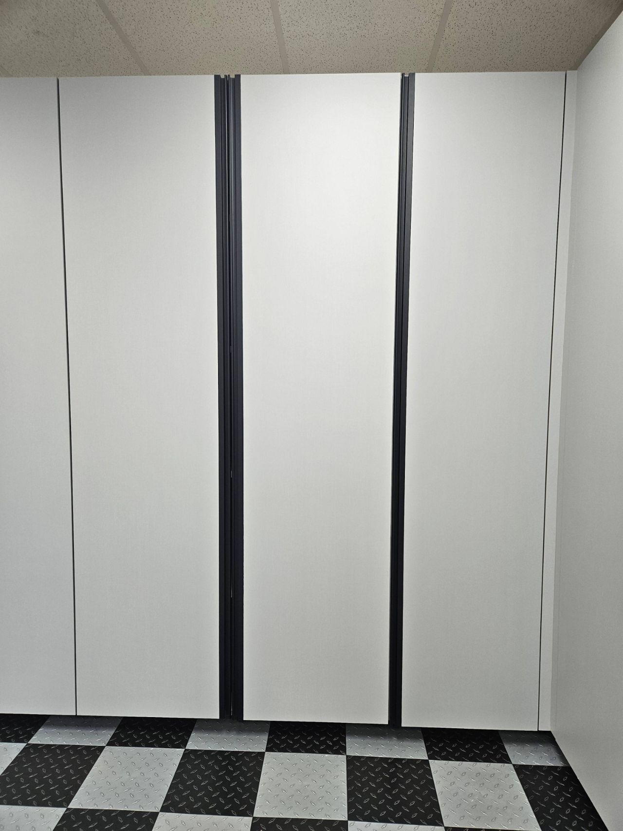 A room with white walls and a checkered floor