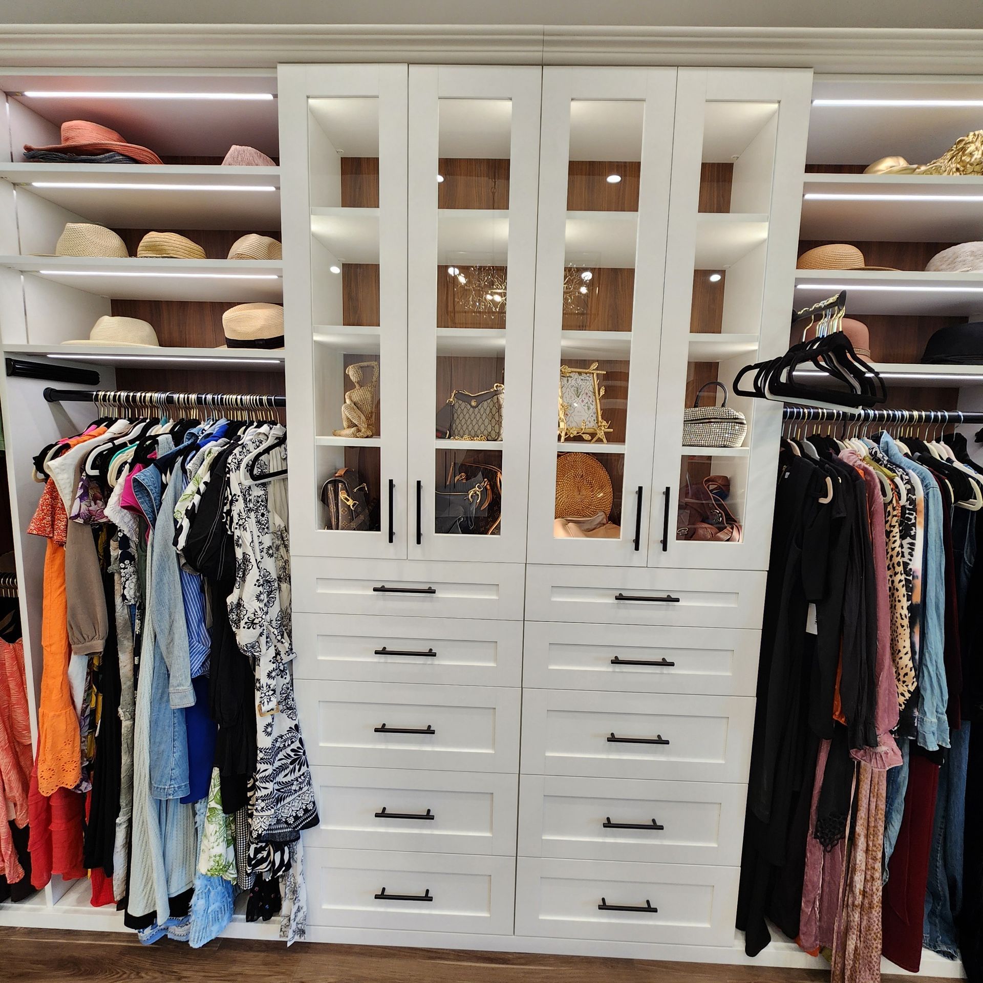A closet filled with lots of clothes and hats