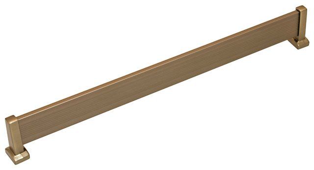 A brass towel bar is sitting on a white surface.
