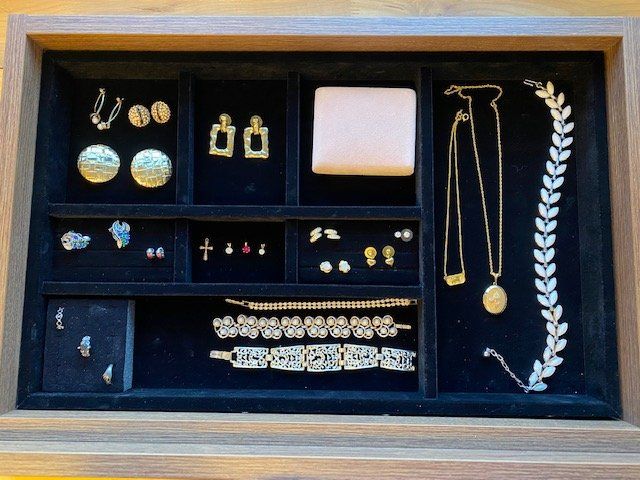 A jewelry tray filled with earrings necklaces and bracelets