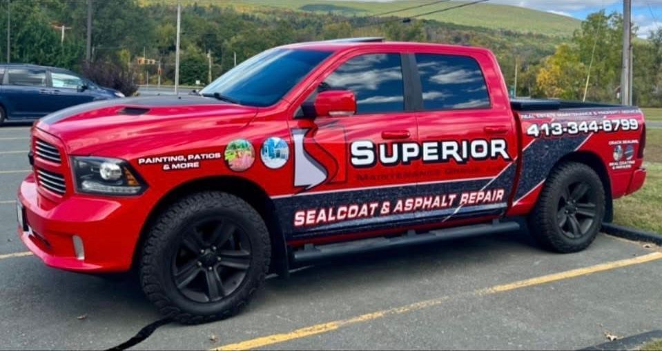 A bright red Dodge Ram truck parked in a lot, branded with 