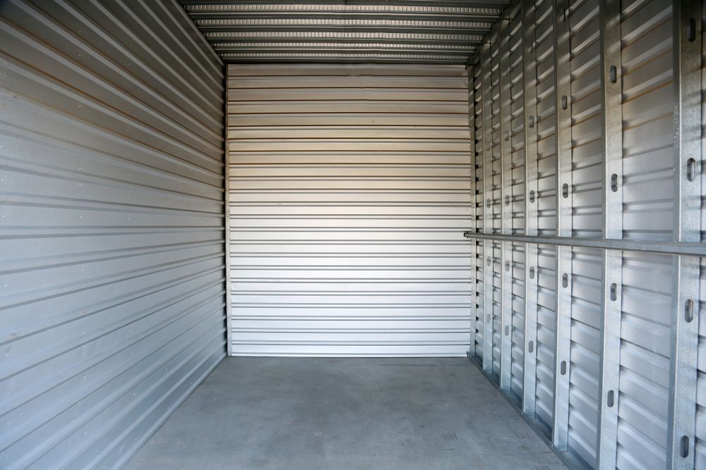 An empty storage unit with a concrete floor