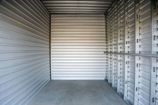 An empty storage unit with a concrete floor