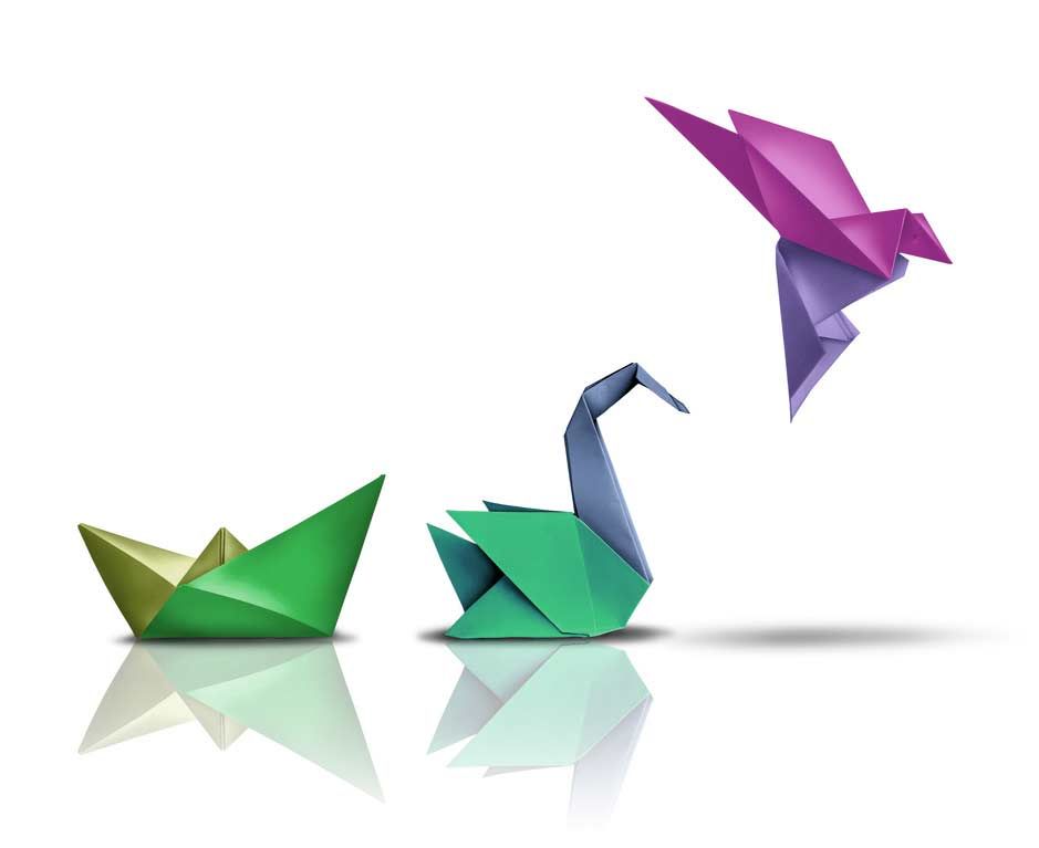 Three origami birds and a green boat on a white background