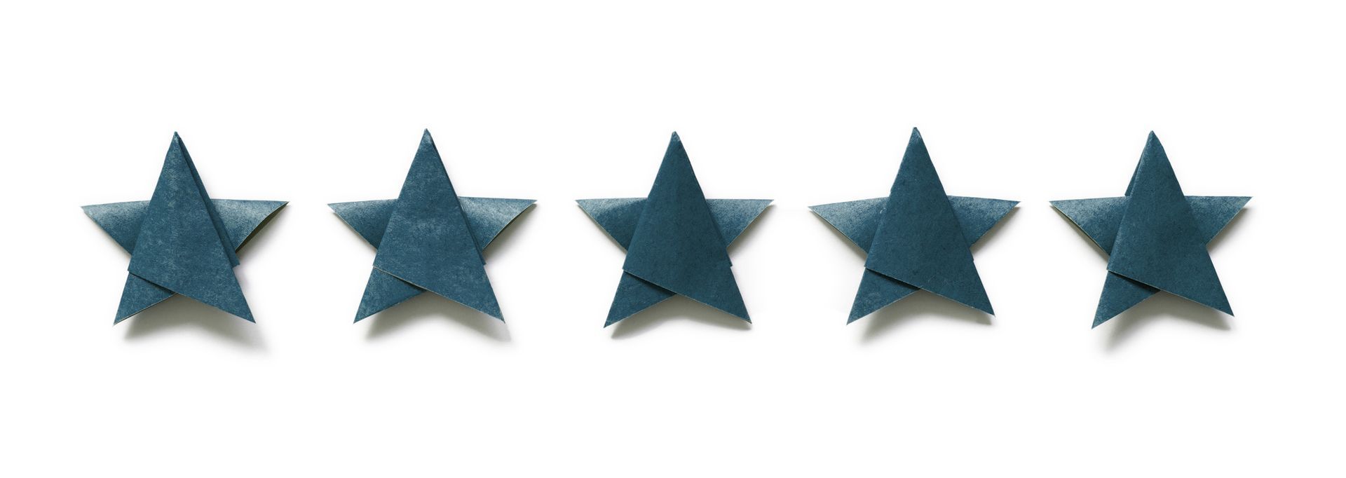 A row of blue origami stars on a white background.