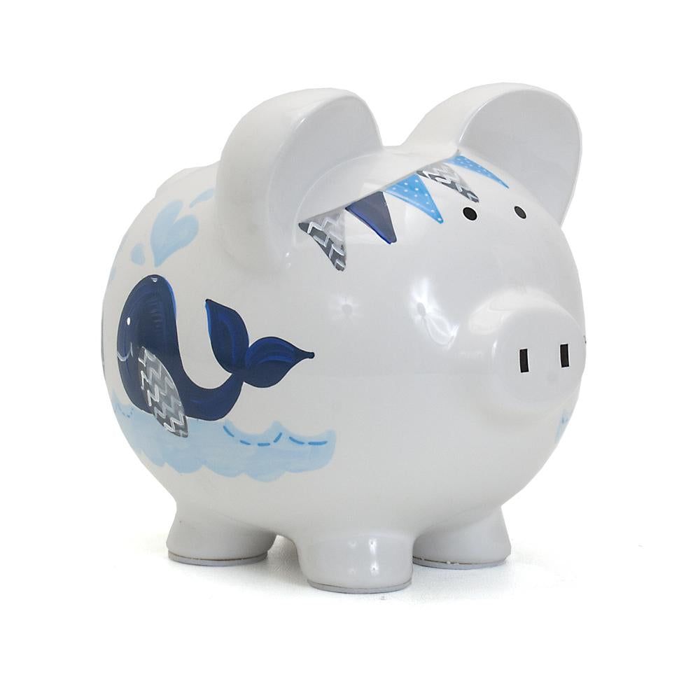 White ceramic piggy bank with blue whale and wave designs