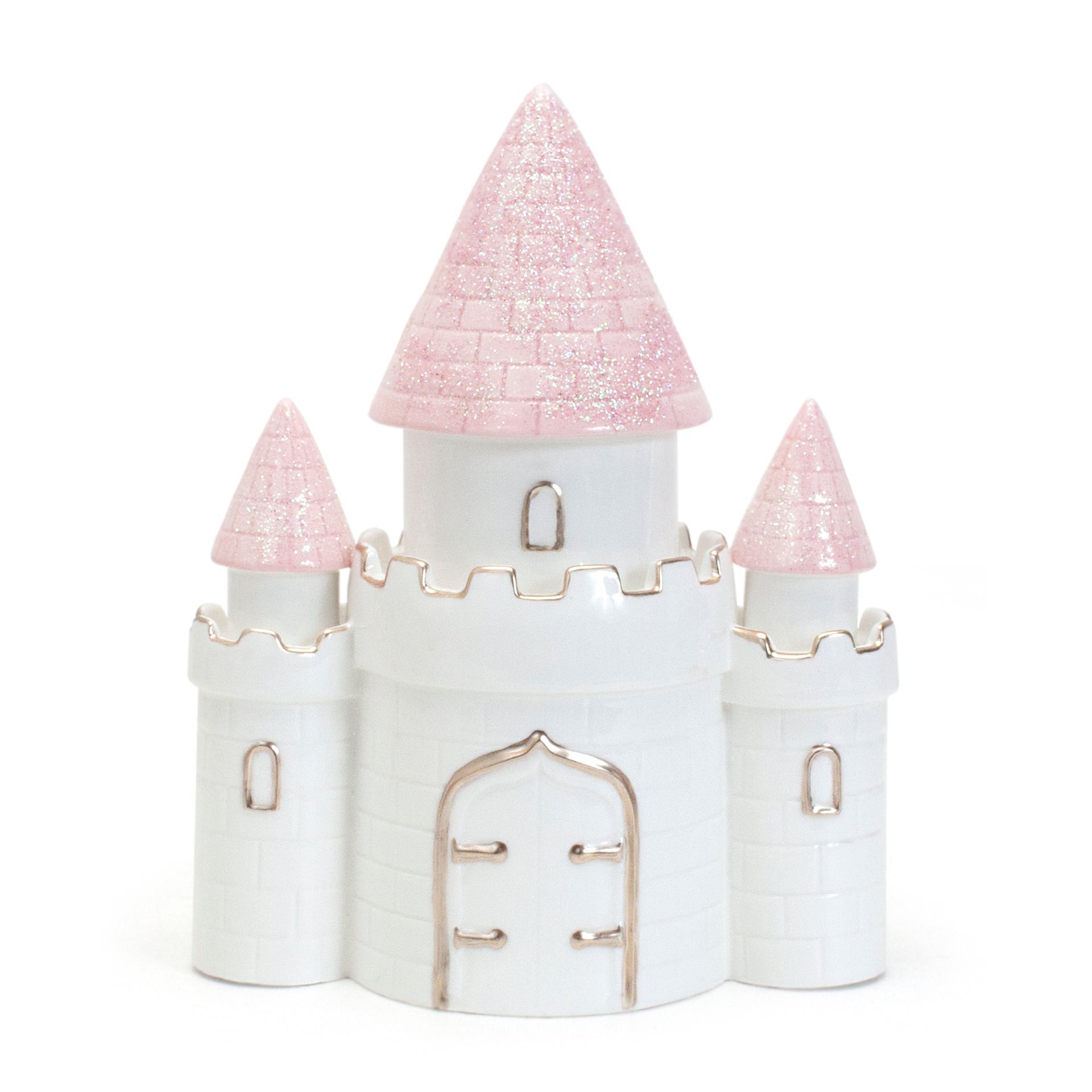 White toy castle with pink glittery conical turrets on a plain background