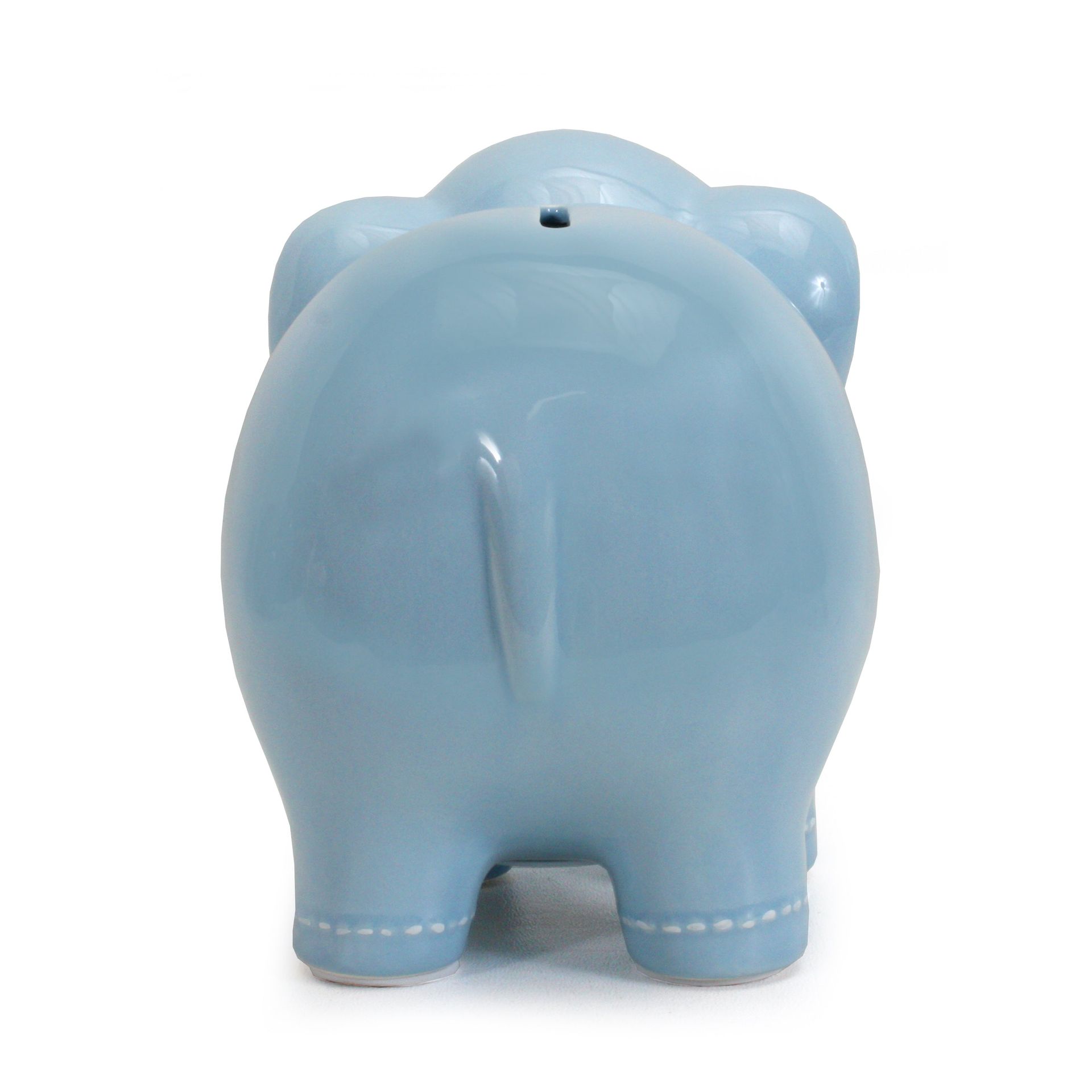 Light blue ceramic piggy bank viewed from the back, with a coin slot on top.