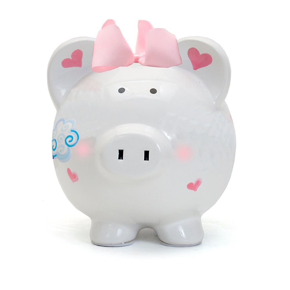White piggy bank with pink bow and heart decorations on a plain background