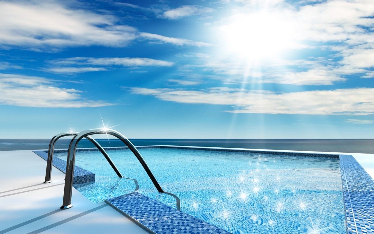 Pool with metal ladder, sparkling blue water, and bright sun over a calm ocean horizon