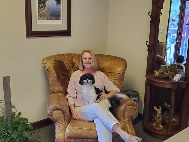 Woman sat on a sofa with dog