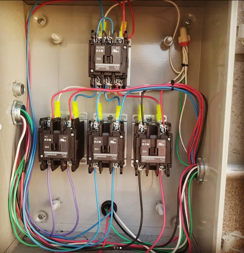 A bunch of wires are connected to electrical boxes