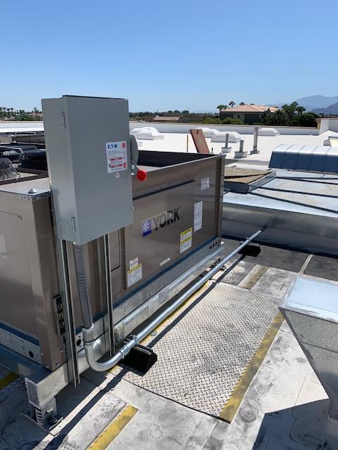 A box on top of a roof with a red button on it.
