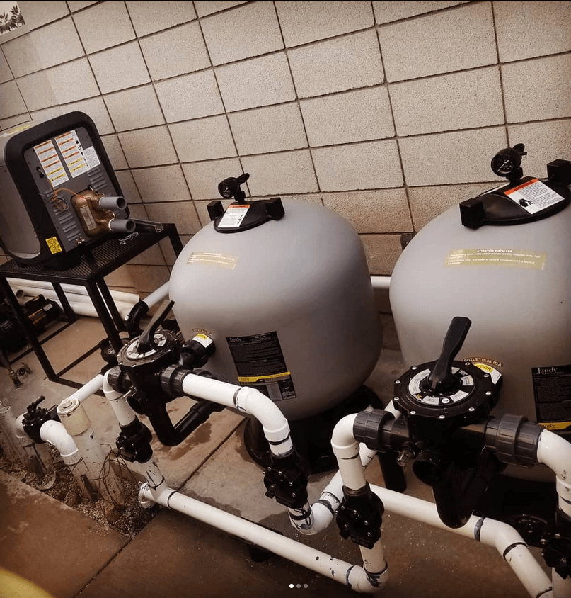 A row of swimming pool filters are lined up in a room