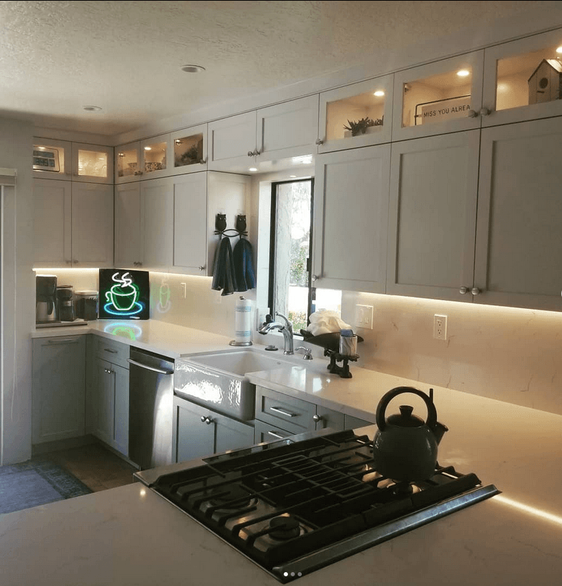 A kitchen with a stove top oven and a sign that says cafe