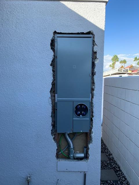 A electrical box is being installed in a hole in a wall.
