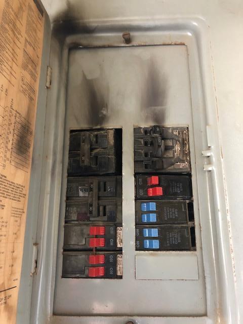 A close up of a electrical box with the door open.