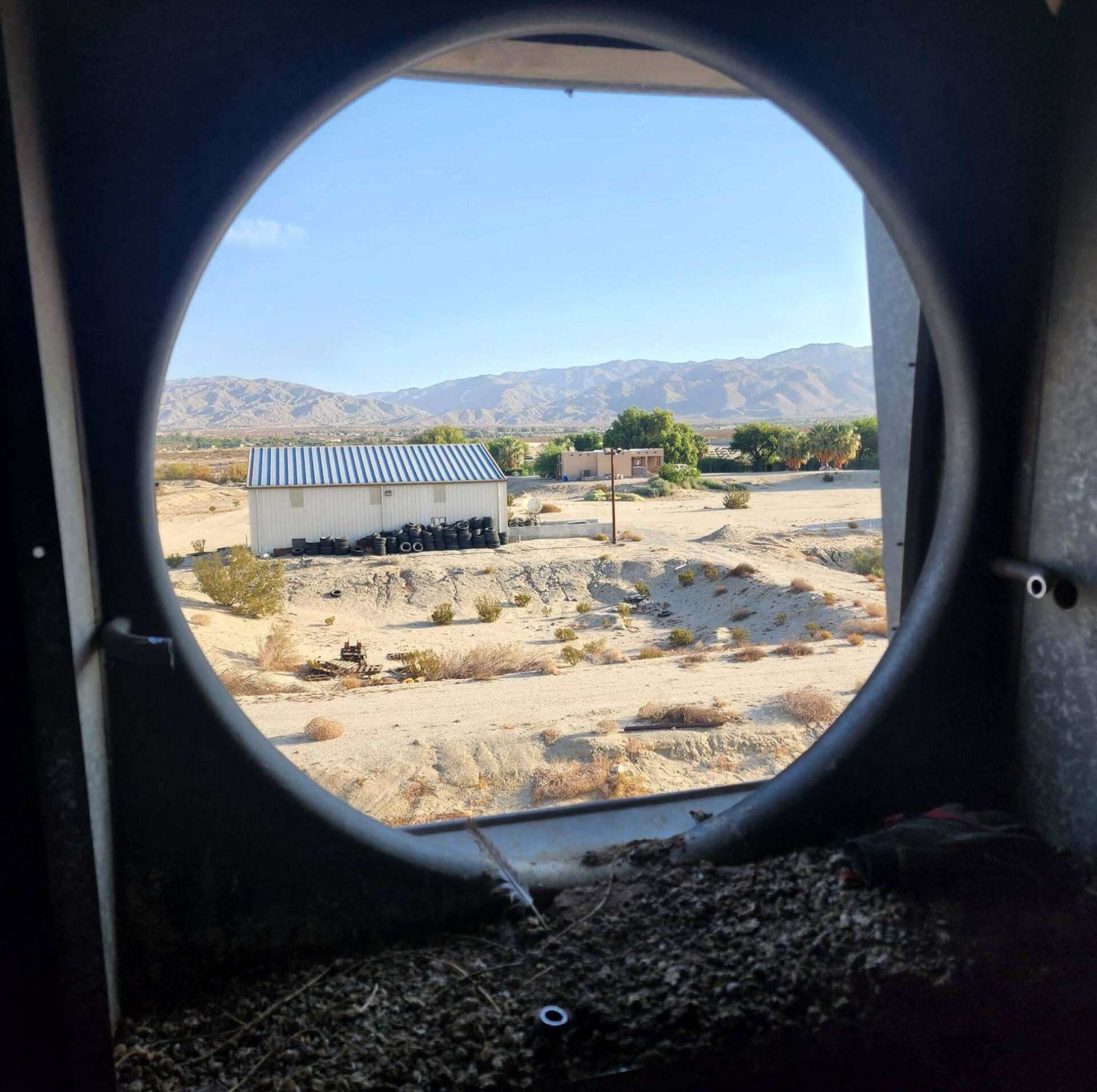 A view of a desert through a round window