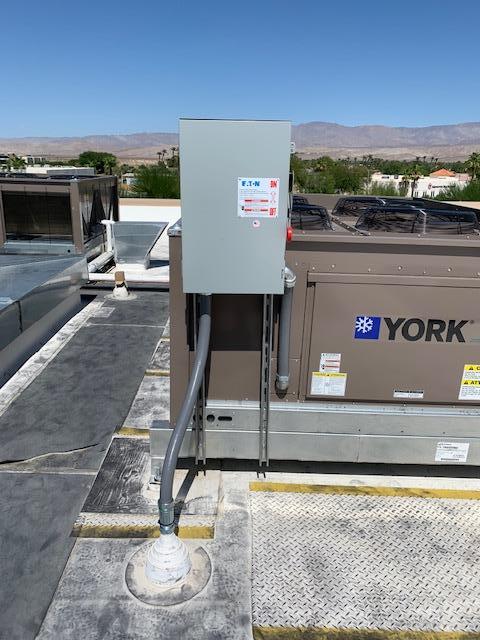 A york air conditioner is sitting on top of a roof.