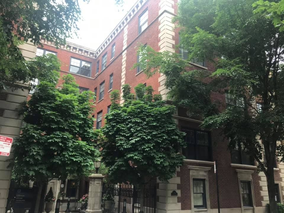 A large brick building with a no parking sign in front of it