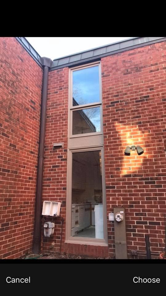 A picture of a brick building with a large window.