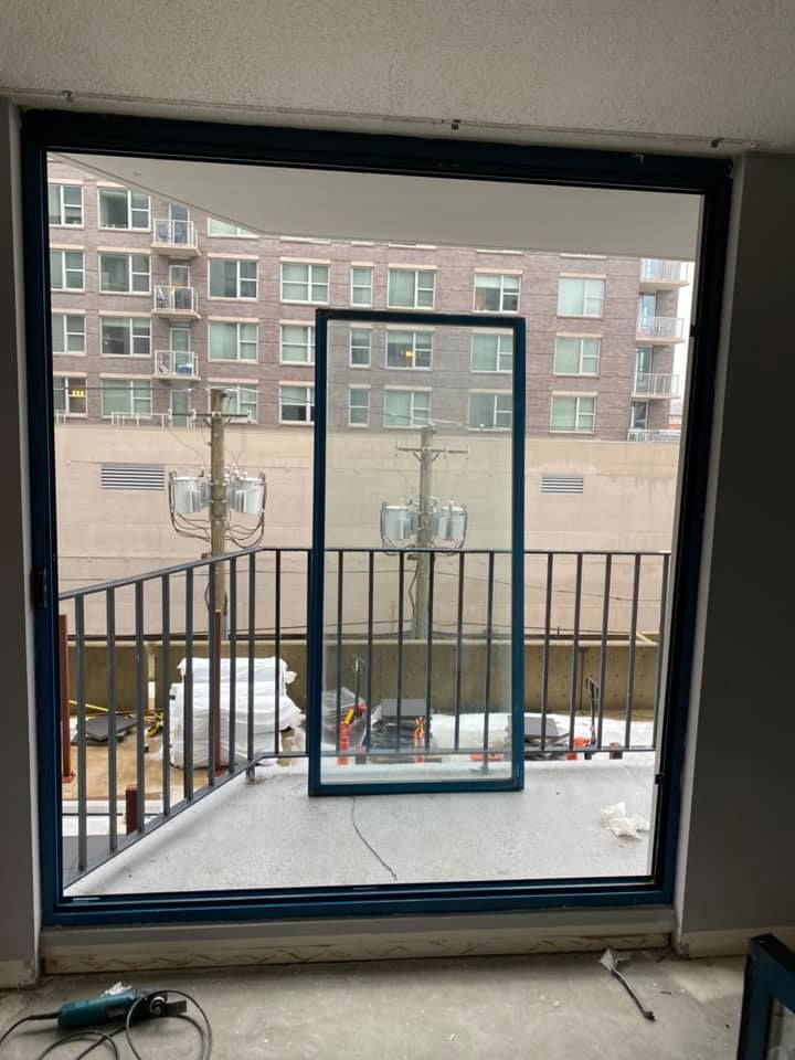 A window with a blue frame is open to a balcony