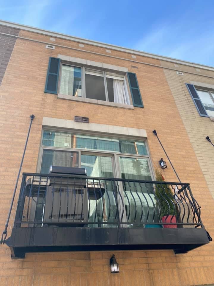 A balcony on the side of a brick building
