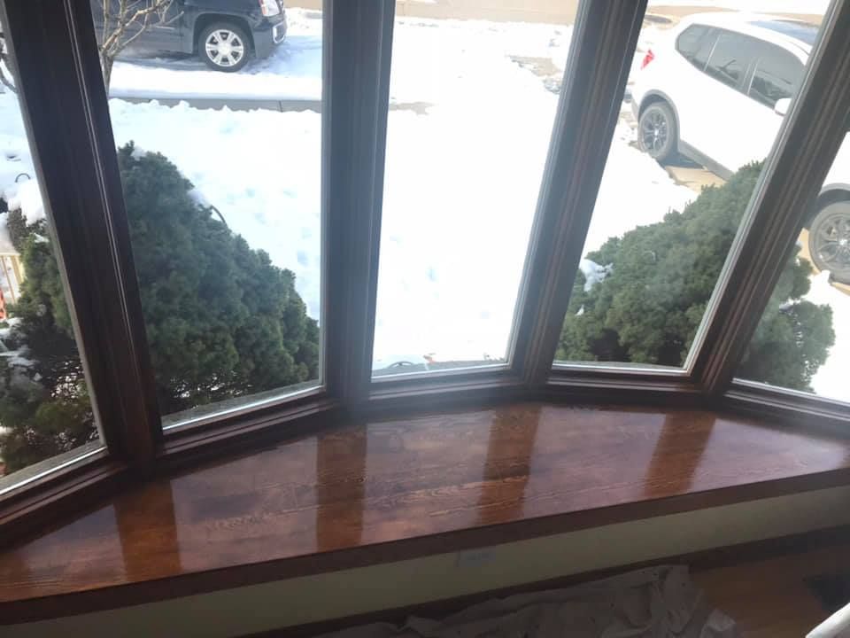 A window with a view of a car parked in the snow