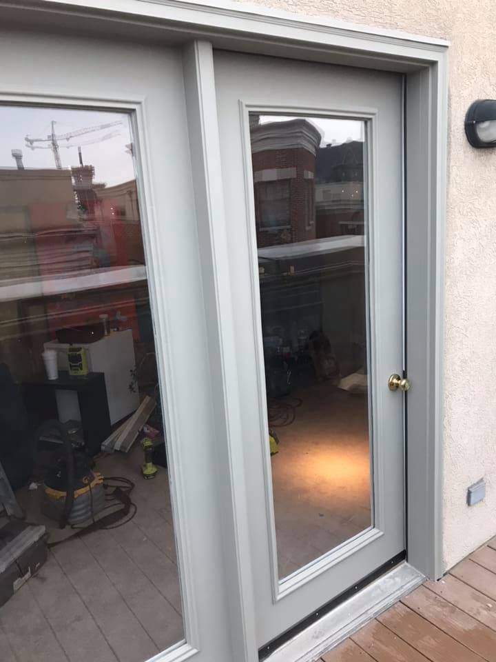 A sliding glass door with a mirror on the side of it.